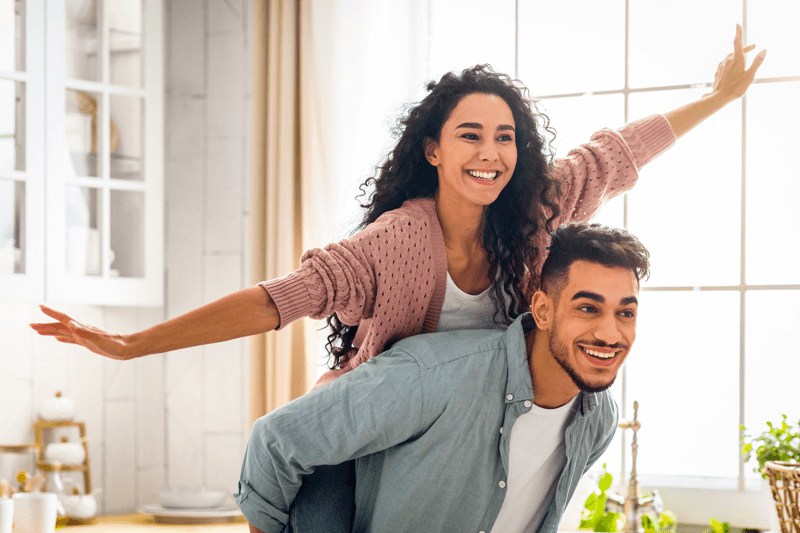 Happy couple enjoying their new space, symbolizing the excitement of working with a real estate agent in Chula Vista.